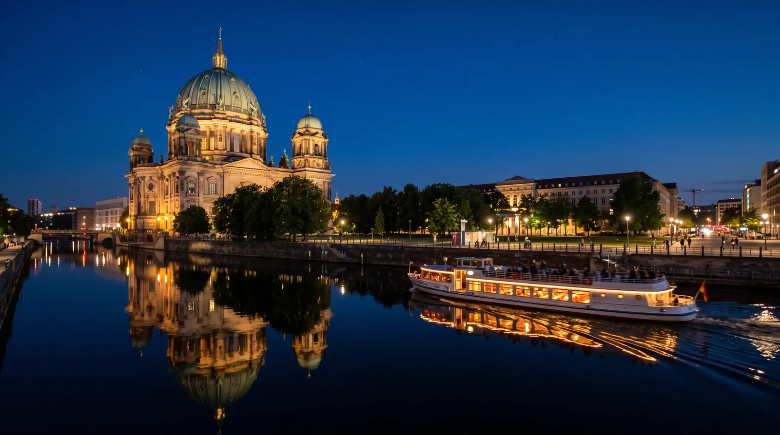 Berlin Cathedral lit at night reflected on the Spree